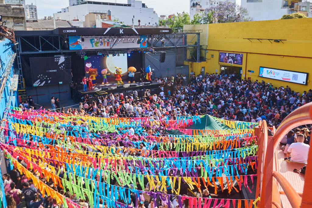 Multi-coloured pennants and a stage with a packed audience at a Unicef Argentina open-air telethon event