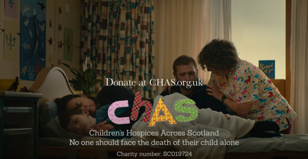 Closing still from CHAS TV advert, with the charity's logo and a call to donate. It features a child nearing end of life with his parents and being supported by CHAS Senior Charge Nurse Jane Carter.