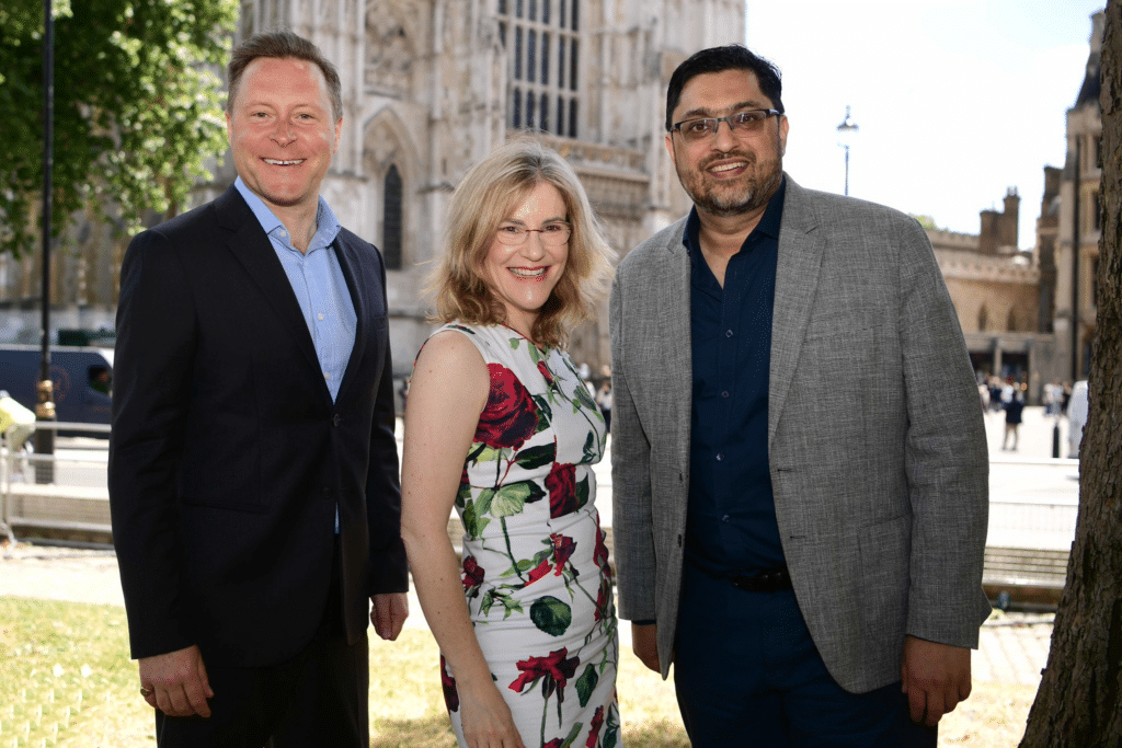 Mark Carrigan, Claire Routley and Haseeb Shabbir stand together outside the Palace of Westminster.