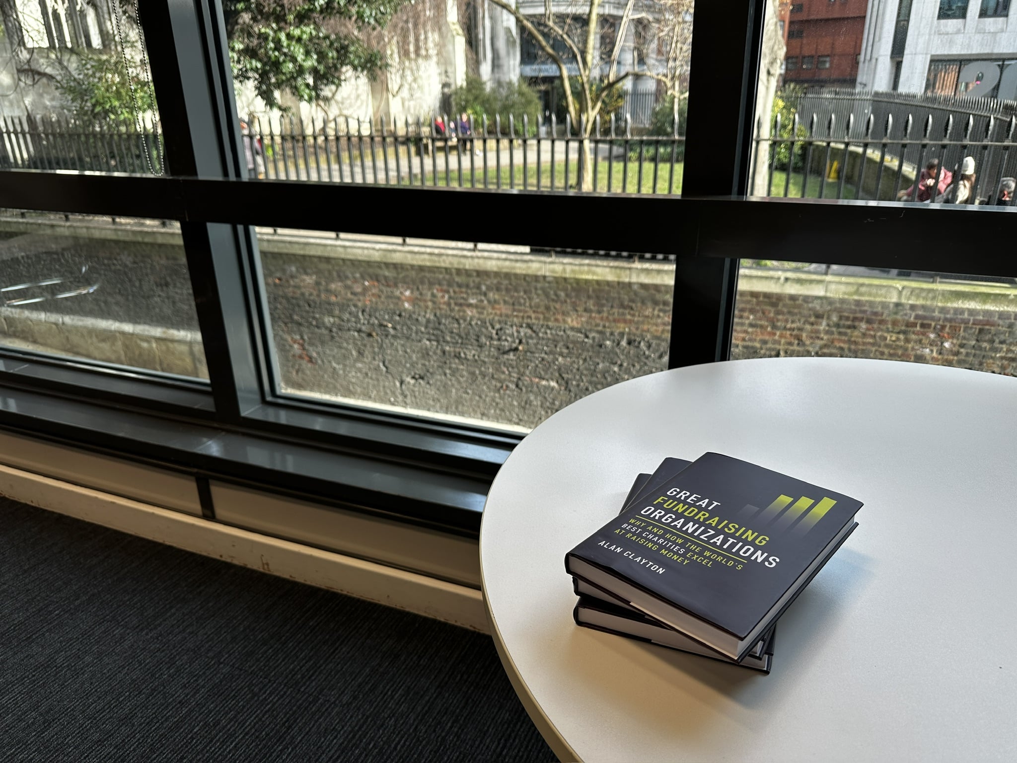 Pile of Great Fundraising Organizations book on a small table in the SSAFA offices in London overlooking St Dunstans in the East gardens.