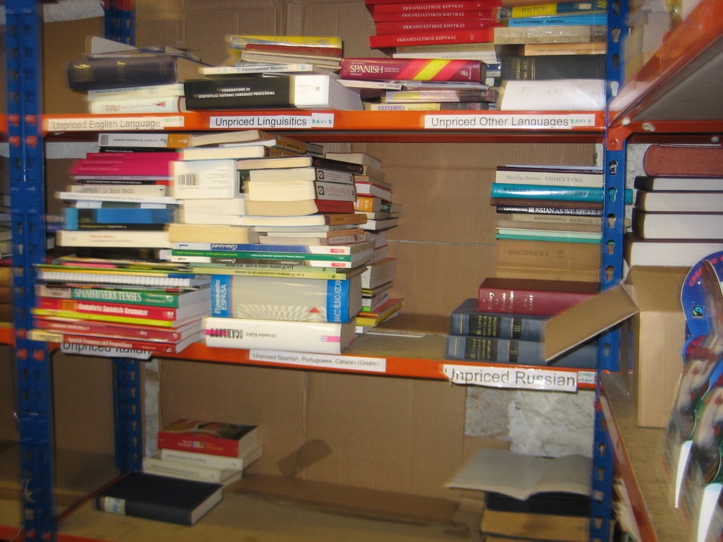 More shelves of unpriced donated books in the basement of the Oxfam Bookshop on St Giles, Oxford.